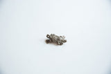 The segmented body and aged bronze finish of a vintage armadillo pendant.