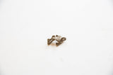 Side view of the vintage African bronze frog pendant highlighting its aged texture and form.