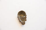 Back view of the vintage African bronze face, revealing hollow interior with rich, aged patina.