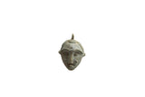 Vintage African bronze face pendant with stylized features and a weathered patina.