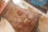 Handmade concentric ridges and aged patina on the antique red slip ware vase.