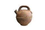 Antique North African red slip ware vase with a bulbous body, top handle, and rustic patina.