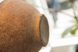 Impressed decorative band and textured surface on the neck of the antique vase.