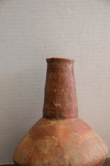 Close view of the handmade neck and rim on the antique red slip ware vase.