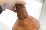 Detail of the handmade form and time-softened patina on the vase neck.