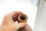 Top view of the antique red slip ware vase, showing the handmade, textured opening.