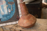 Collectible antique North African vase showing its handmade form and aged red patina.