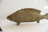 Textured scales and fins of the vintage African fish sculpture with aged bronze patina.