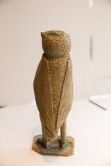 The back of the vintage African owl sculpture shows its carved, linear wing details.