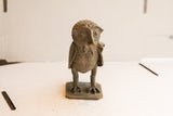 The vintage African owl sculpture with a rat, highlighting its detailed handmade texture.