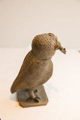 Textured head and carved feather details on the back of the African owl sculpture.