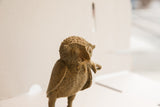 Textured head of the vintage handmade African owl sculpture with rat.