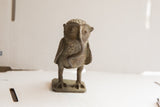 Handmade African sculpture of an owl with a snake, showing a dark, textured patina.