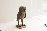 Detailed texture of the collectible vintage African owl sculpture's head and body.