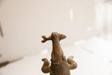 A view from below showing the fish in the mouth of the African crocodile sculpture.