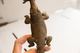 Overhead view of the hand-carved, grid-like scale pattern on the African crocodile sculpture.