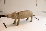 Rear view of a vintage boar sculpture highlighting its textured, aged finish.