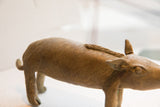 Coarse, hand-molded texture and ridged spine on a vintage African boar figure.