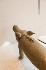 Hand-carved spine texture and prominent ears of the vintage African boar sculpture.