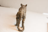 Rear view of the cheetah sculpture showing textured patterns on its back and tail.