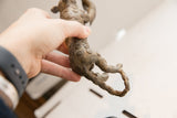 Side view of the vintage cheetah sculpture showing the textured spiral pattern on its hind legs and tail.