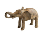 Vintage handmade African elephant sculpture with a weathered brown patina and curled trunk.