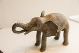 Profile of the vintage African elephant sculpture, highlighting its textured, aged patina.