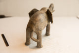 The textured, aged finish on the back of a handmade vintage elephant sculpture.