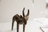 Aged patina and handmade texture on the face of a vintage African antelope sculpture.