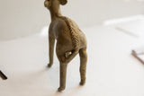 Rear view of a vintage antelope sculpture highlighting its textured, braided spine detail.