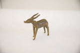 Side profile of the vintage handmade African antelope sculpture showing its form and aged patina.