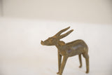 Profile of the vintage African antelope sculpture showing its stylized head and aged texture.