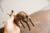 Handmade texture and aged patina visible on the back of a vintage African ewe sculpture.