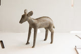 Profile view of a vintage African Ewe sculpture with a textured spine and aged finish.