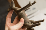 Underside of the vintage African ewe sculpture, detailing its rustic texture and form.