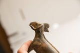 Upward view of the handmade ram sculpture's head showing its aged texture.