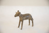 Three-quarter profile of a vintage handmade African ram sculpture with a weathered patina.