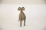 Back view of the vintage ram sculpture, showing its curled tail and textured, aged surface.
