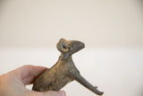 Vintage African ram sculpture held in hand to demonstrate its scale and aged texture.