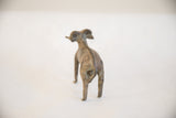 Rear view of the vintage African ram sculpture highlighting the textured detail of its spine.