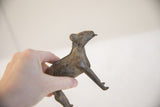 Upward-gazing profile of the vintage African ram sculpture held in a hand.