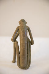 Back view of the vintage African monkey sculpture, detailing its stylized form and weathered patina.