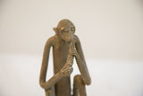 Upper body close-up of the vintage monkey sculpture highlighting its aged metal patina.