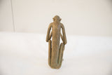 Back view of the vintage sitting monkey sculpture showing its slender form and aged patina.