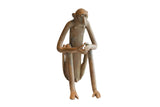 Vintage African sitting monkey sculpture with long limbs and a weathered, earthy patina.