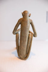 Back view of the vintage monkey sculpture, showing its stylized, slender form and textured patina.