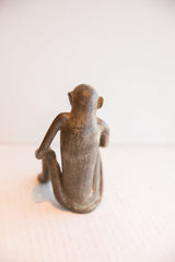 Rear view of the vintage African monkey figurine showing its slender back and aged patina.