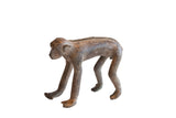 Vintage African monkey figurine with a dark, aged finish and hand-carved details along its back.
