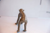 Rear view of the handmade African monkey figurine highlighting its textured spine.