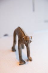 Close-up of the vintage African monkey sculpture's face showing its aged, handmade character.